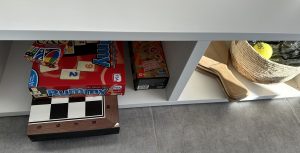 Games and tennis rackets in the living-room sideboard