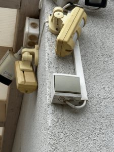 Outdoor light switch on the side of the house