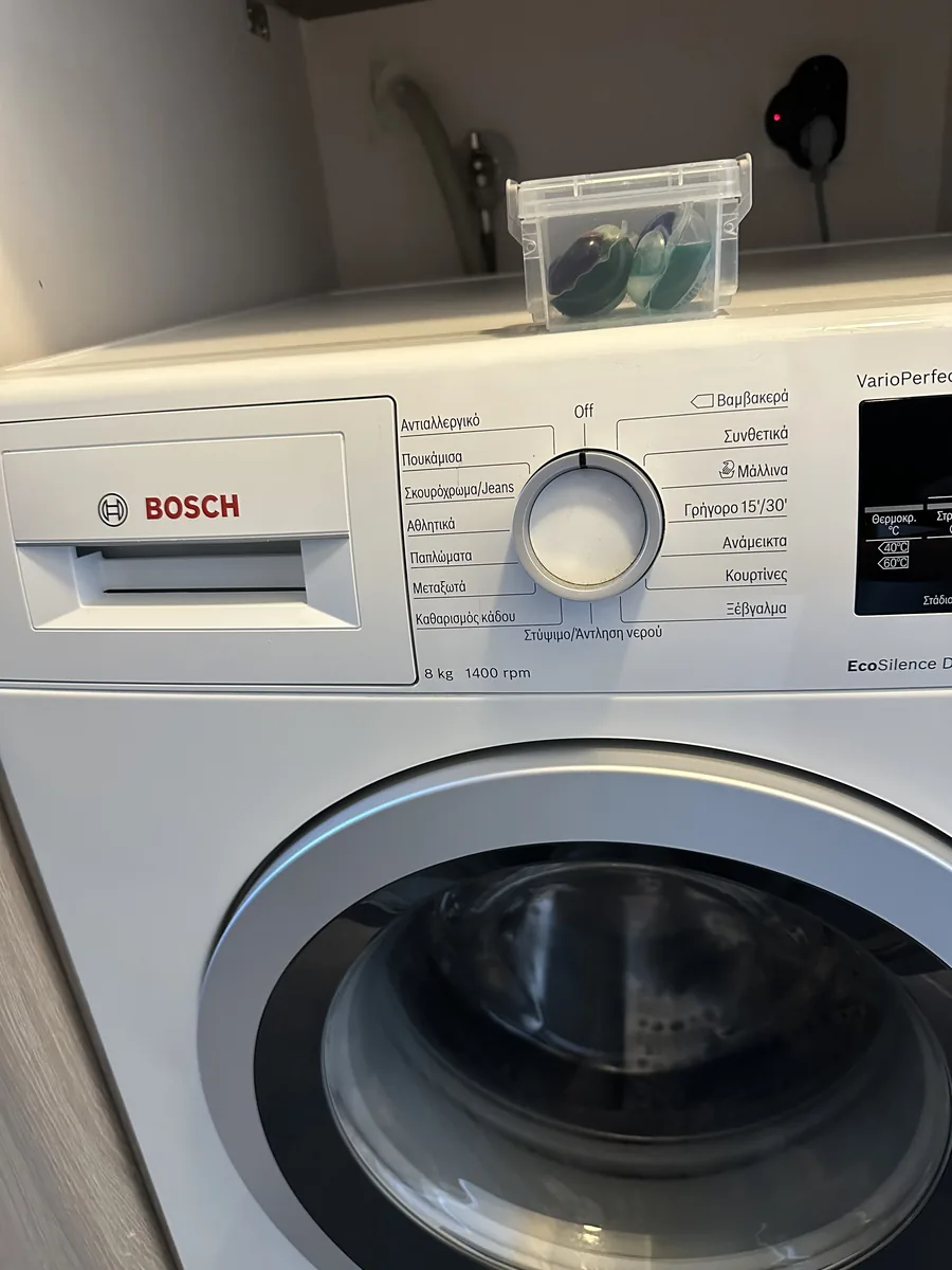 Bosch washing machine in front of the downstairs bathroom